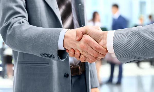 depositphotos 12375049 stock photo handshake in front of business